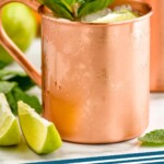 Pinterest graphic for Kentucky Mule recipe. Image is close up photo of Kentucky Mule served in a copper mug and garnished with slice of lime and mint leaves. Text says, "Kentucky Mule simplejoy.com"