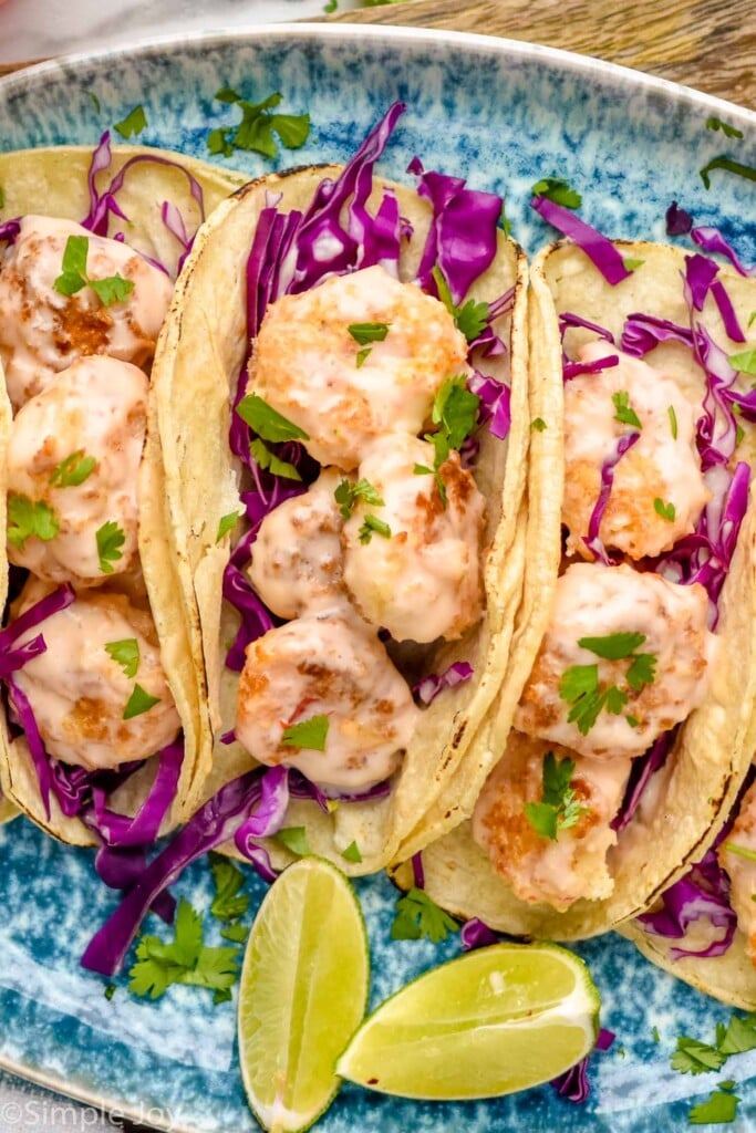 Overhead photo of Bang Bang Shrimp Tacos and lime wedges