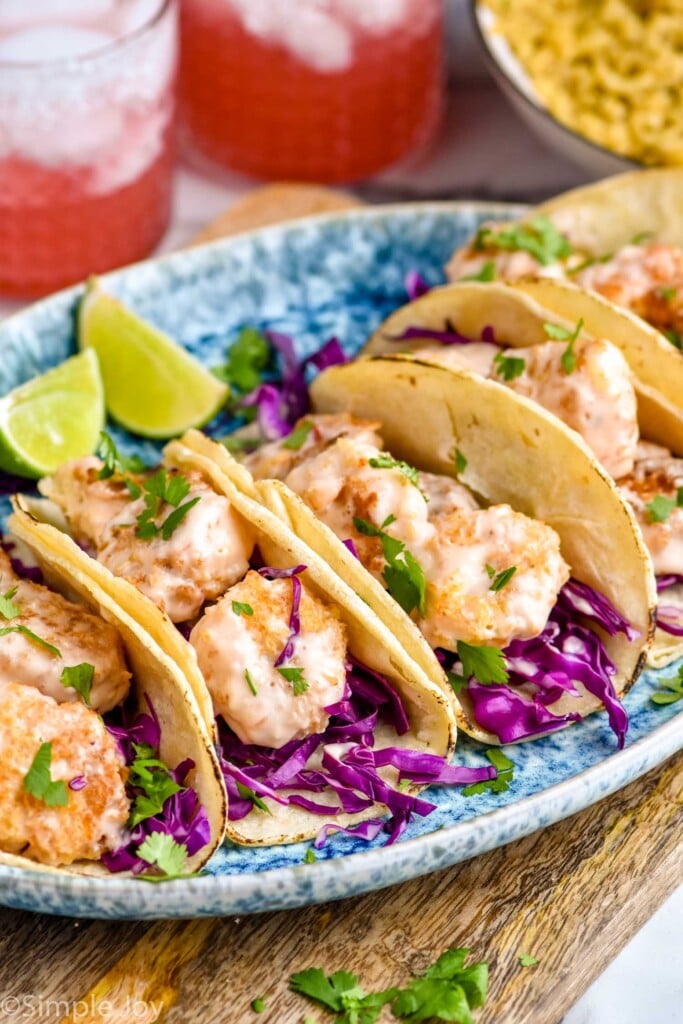 Overhead photo of Bang Bang Shrimp Tacos and lime wedges.