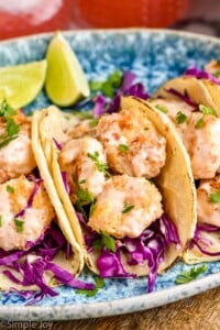 Overhead photo of Bang Bang Shrimp Tacos and lime wedges.