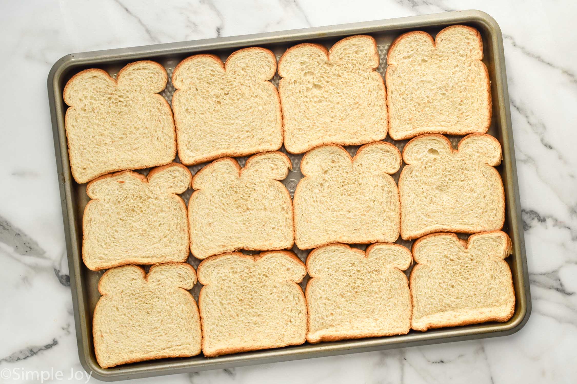 Overhead photo of a baking sheet with slices of bread for Breadcrumbs recipe.