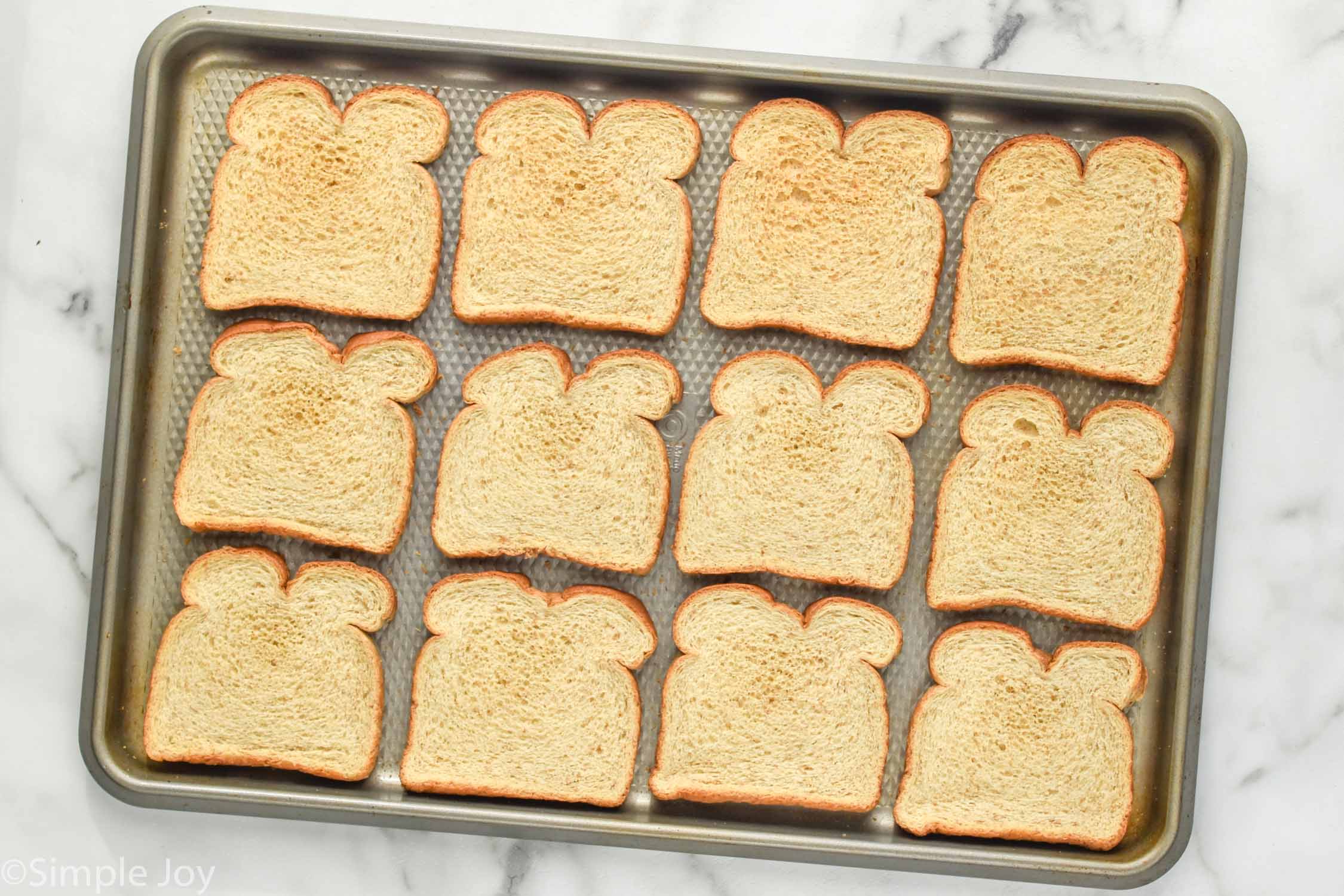 Overhead photo of a baking sheet with slices of bread for Breadcrumbs recipe.