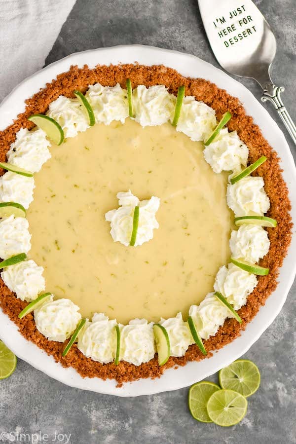 Overhead photo of Key Lime Pie. Serving spatula on counter beside Key Lime Pie that says, "I'm just here for dessert."