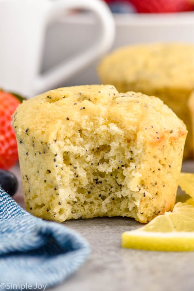 Close up photo of a Lemon Poppy Seed Muffin with a bite taken out.