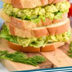 Pinterest graphic for Avocado Egg Salad recipe. Image is photo of a stack of two Avocado Egg Salad sandwiches. Text says, "Avocado Egg Salad simplejoy.com"