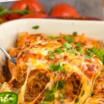 Pinterest graphic for Beef Enchiladas recipe. Text says, "Easy & delicious Beef Enchiladas simplejoy.com." Image is close up photo of a spatula serving a piece of Beef Enchiladas from baking dish.
