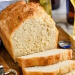 Pinterest graphic for Beer Bread recipe. Text says, "3 ingredient beer bread simplejoy.com" Image is overhead photo of a loaf of Beer Bread that is partially sliced.