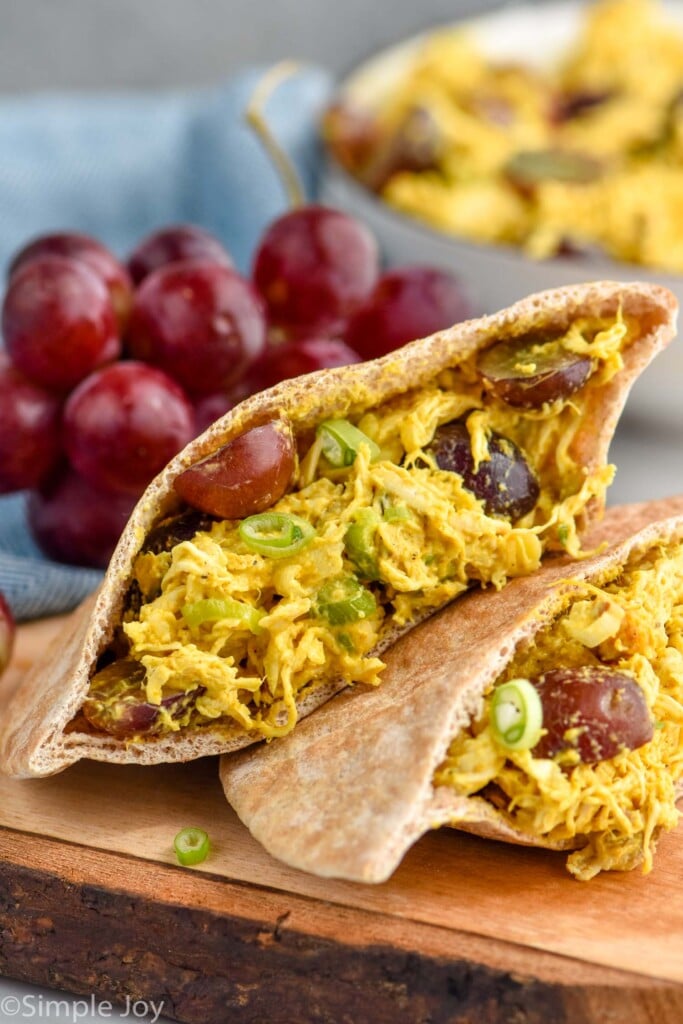 Close up photo of Curry Chicken Salad. Grapes and extra Curry Chicken Salad in background.