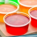 Pinterest graphic for Jello Shots recipe. Image is overhead photo of Jello Shots. Text says, "Jell-o shots simplejoy.com."