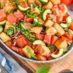 Pinterest graphic for Panzanella Salad recipe. Photo is side view of Panzanella Salad. Tomatoes next to bowl of Panzanella Salad. Text says, "Panzanella Salad simplejoy.com"