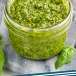 Pinterest graphic for Pesto Sauce Recipe. Image is overhead photo of a jar of Pesto sauce. Text says, "Pesto Recipe simplejoy.com"