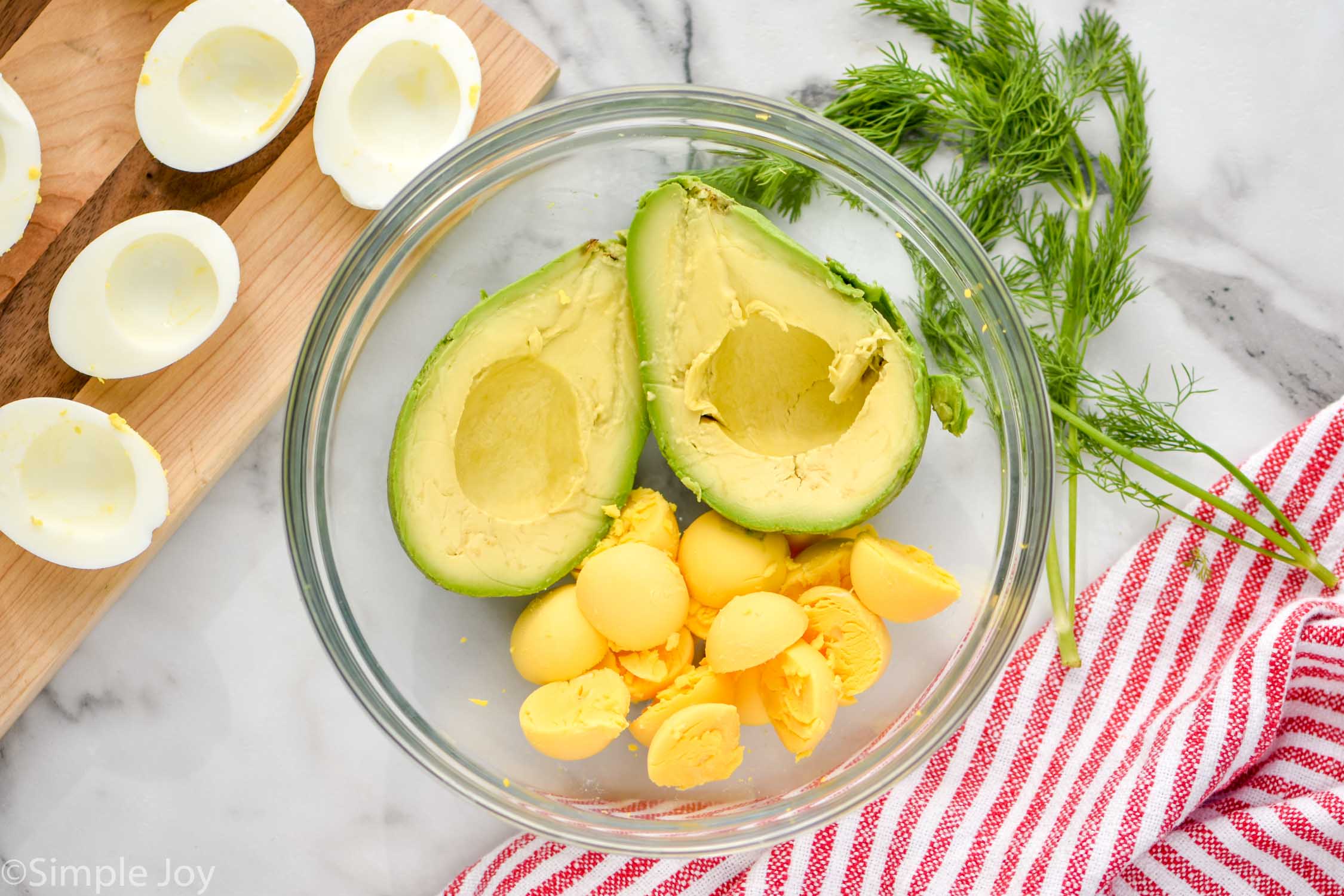 Overhead photo of bowl of ingredients for Avocado Egg Salad recipe.