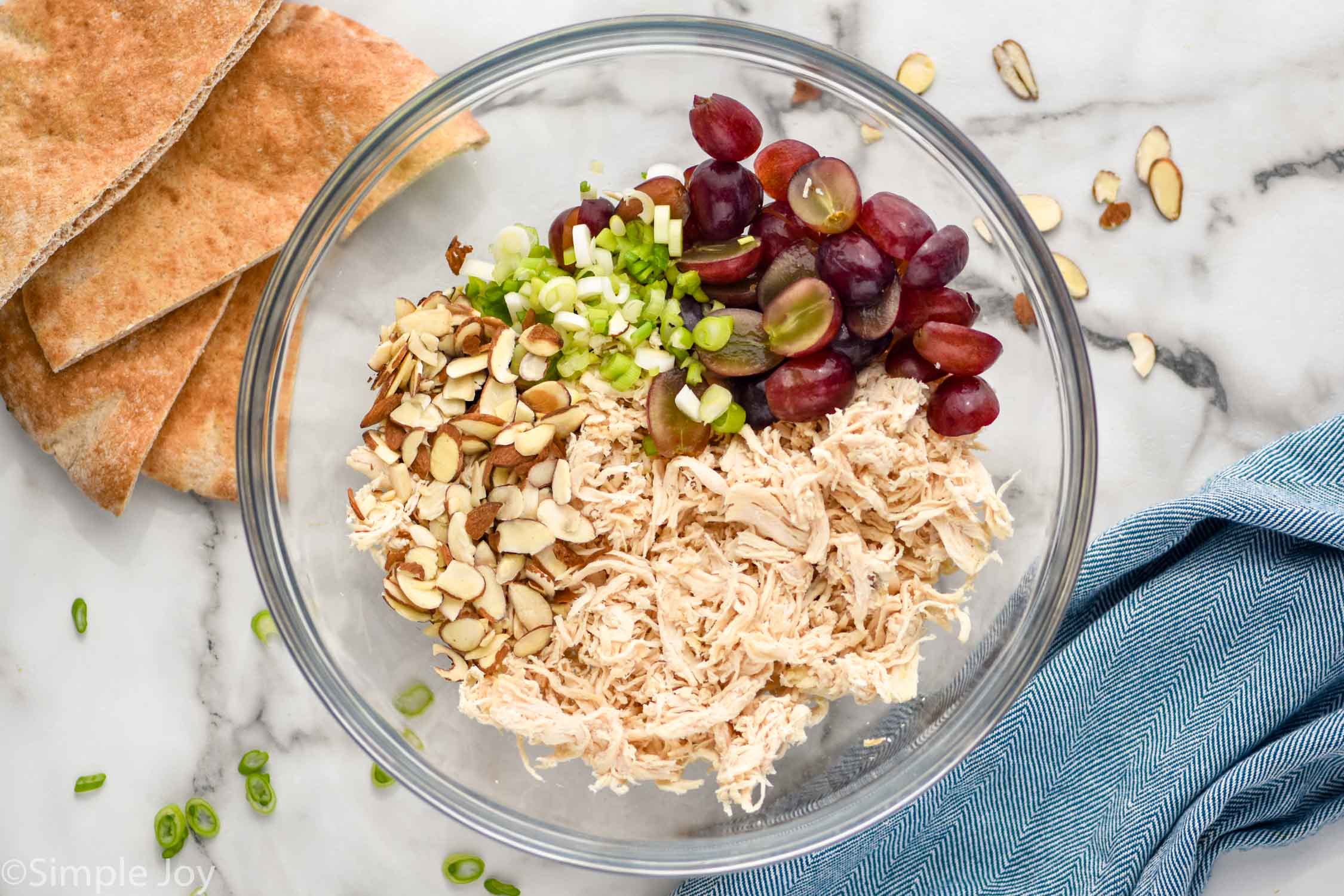 Overhead photo of mixing bowl of ingredients for Curry Chicken Salad recipe.