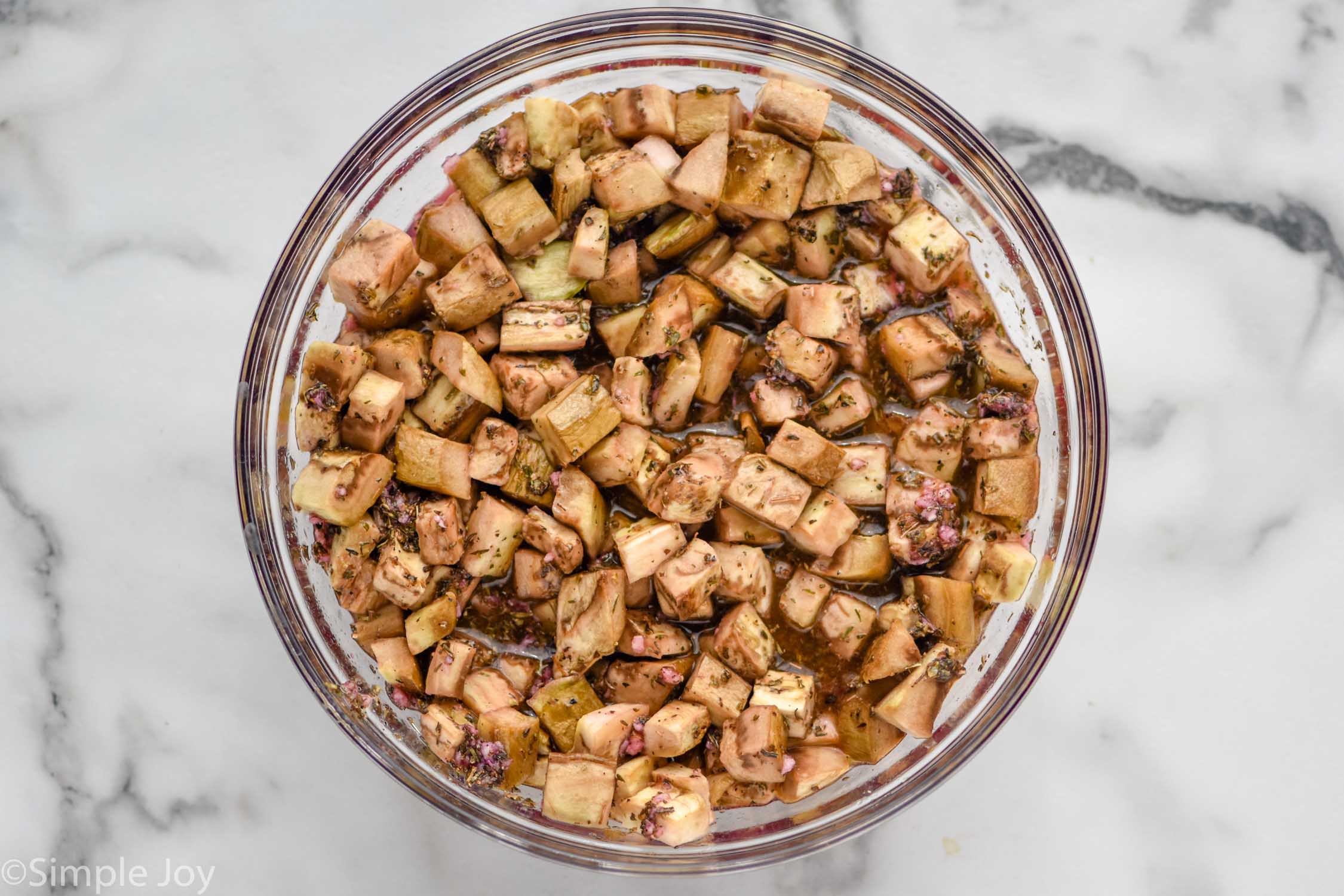 Overhead photo of a bowl of ingredients for Eggplant Salad recipe.