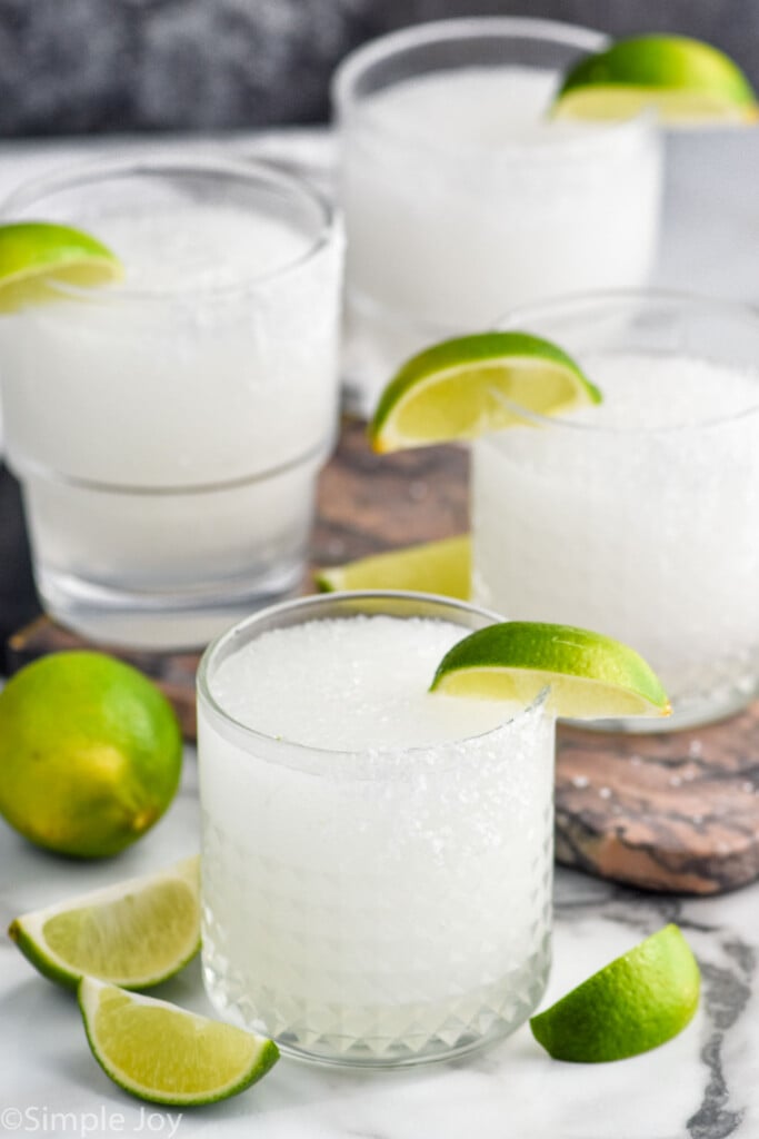 Overhead photo of Frozen Margaritas garnished with lime slices