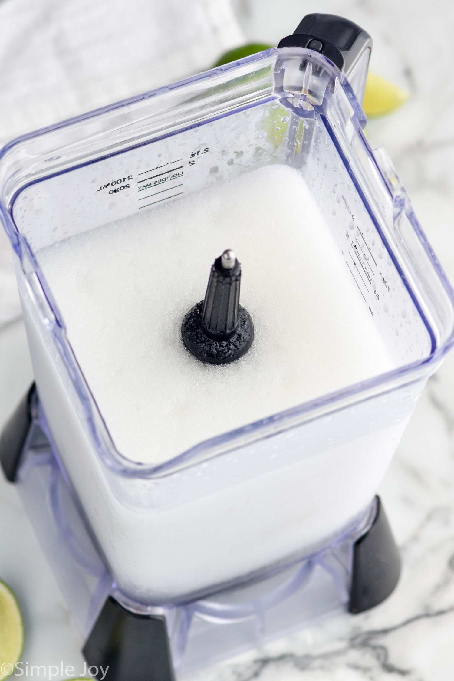 Overhead photo of a blender of ingredients for Frozen Margarita recipe.