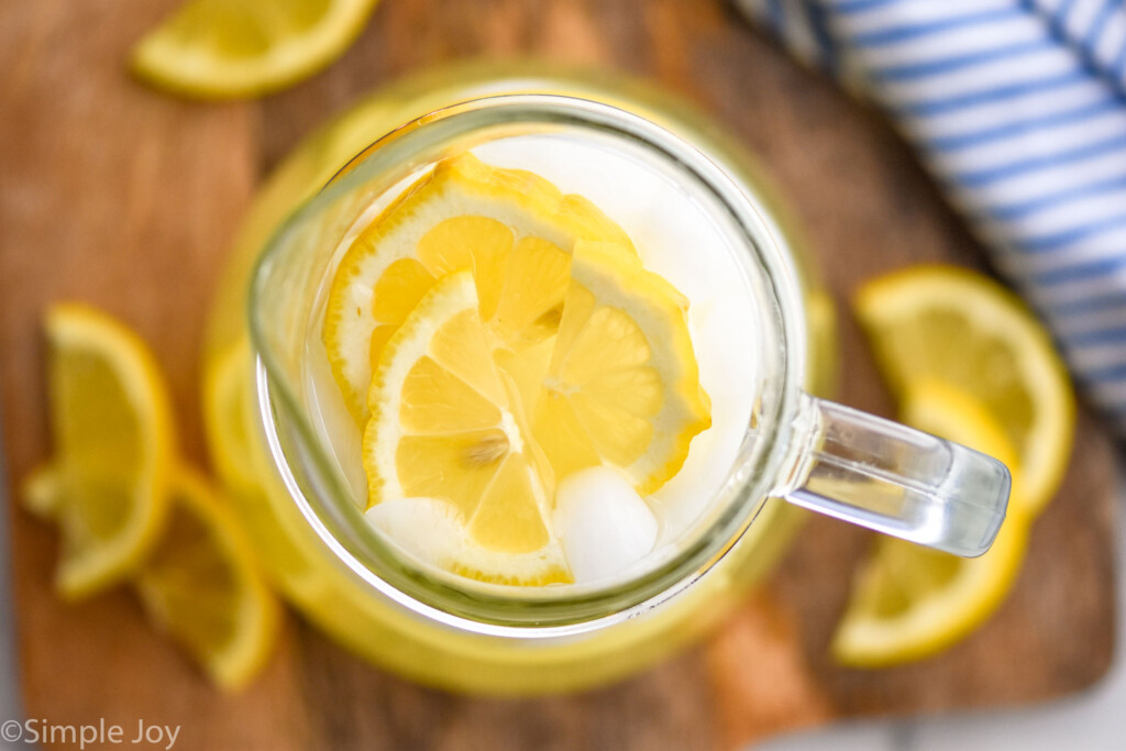 Overhead photo of a pitcher of Lemonade garnished with slices of lemon.