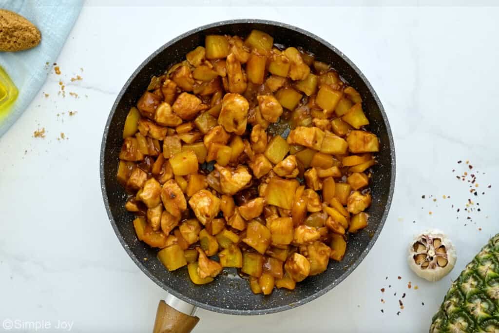 overhead of skillet of pineapple chicken ingredients