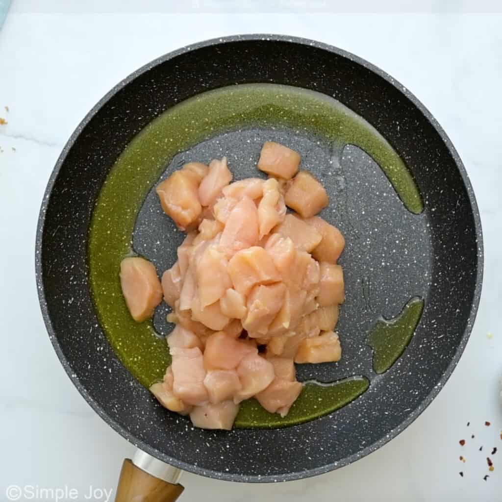 overhead of skillet of oil and chicken to make pineapple chicken