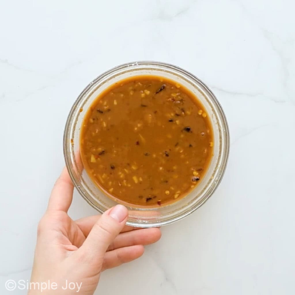 overhead of a bowl of sauce for pineapple chicken mixed