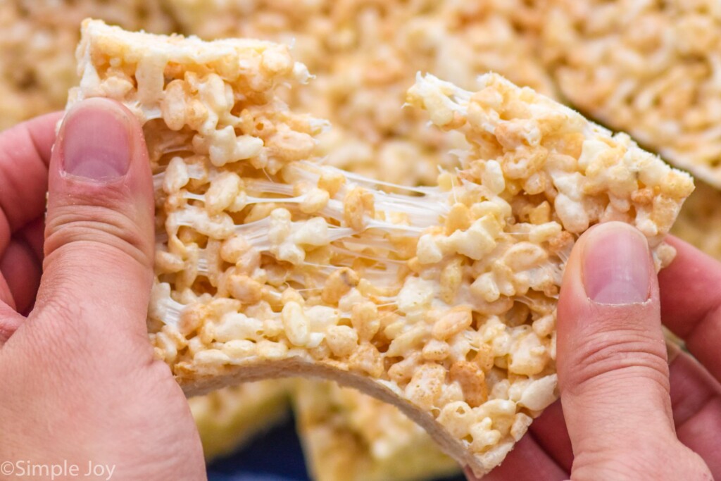 Overhead photo of person's hand pulling apart Rice Krispie Treat