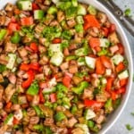 Overhead photo of Eggplant Salad with salad tongs beside bowl. - 10