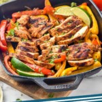 Pinterest graphic for chicken fajitas. Image shows a grill pan of chicken fajitas with a bowl of guacamole and fresh tomatoes sitting in background. Text says "Chicken fajitas simplejoy.com"