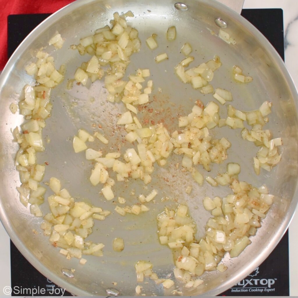 garlic and onion being sauteed in a pan