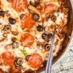 overhead of a skillet of pizza casserole being spooned up, says: "one pot pizza casserole simplejoy.com"