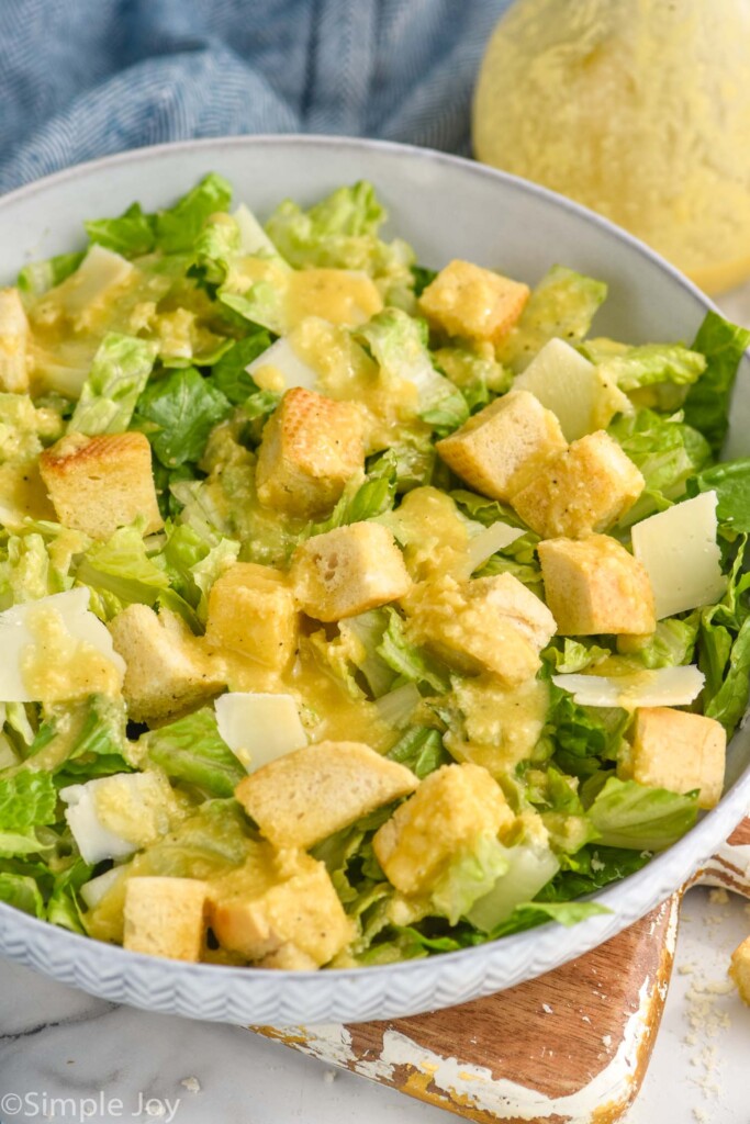 Bowl of caesar salad made with caesar dressing and croutons