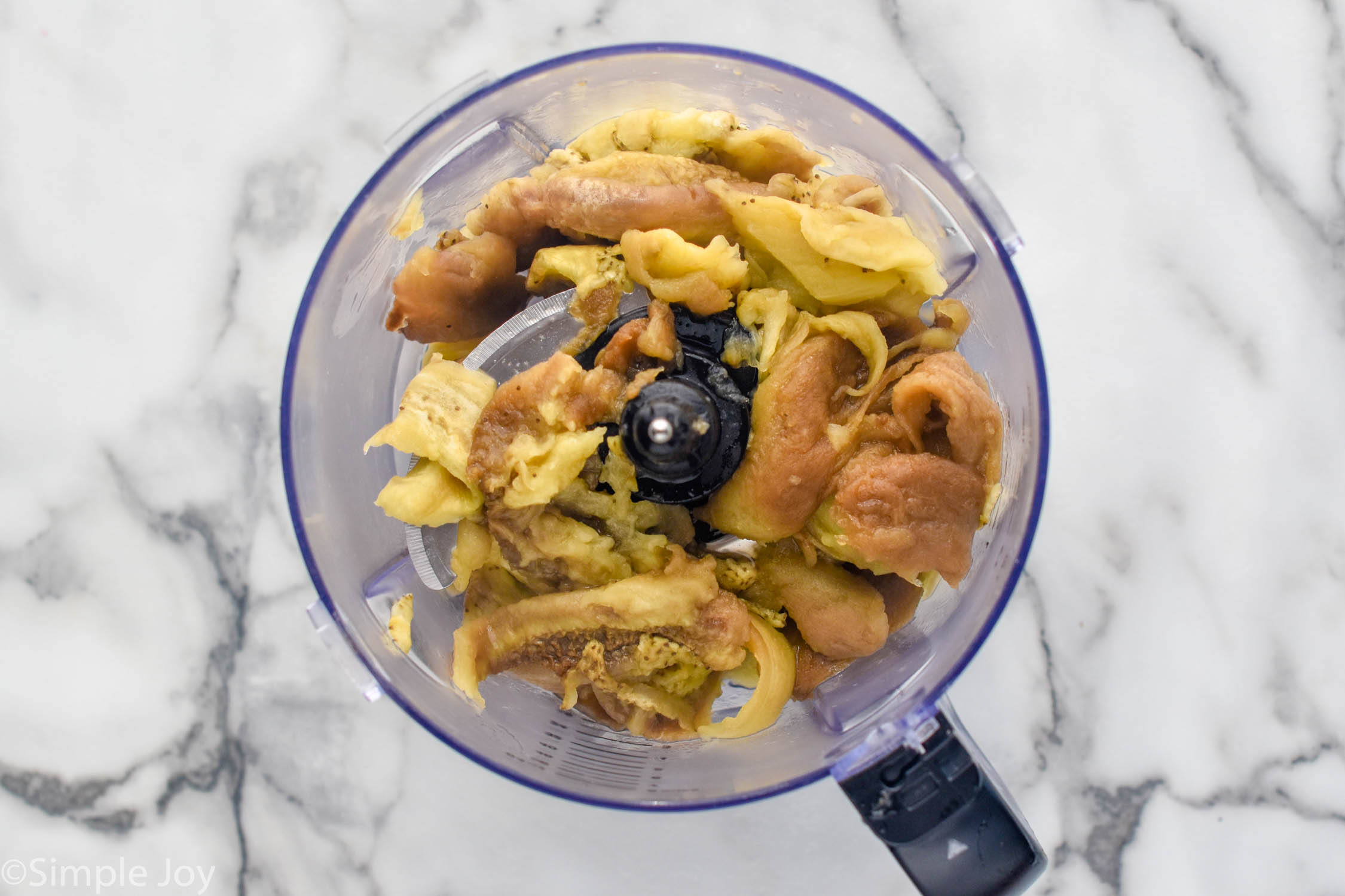 overhead of a food processor with Baba Ganoush ingredients