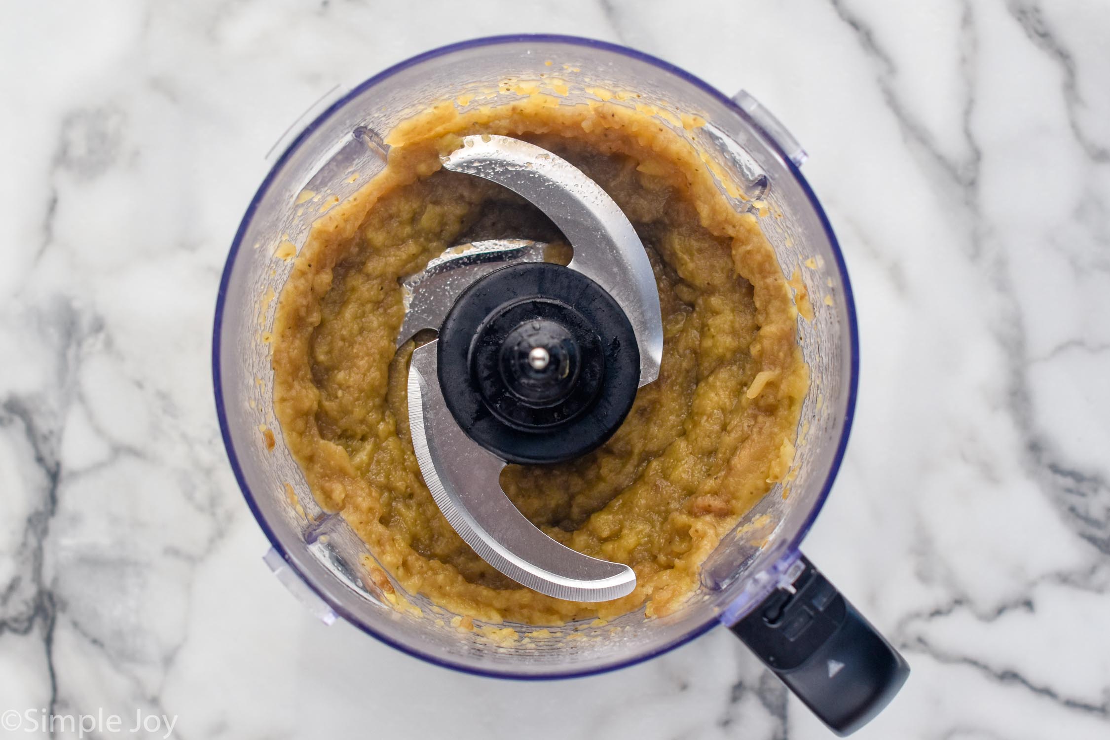 overhead of a food processor with Baba Ganoush ingredients