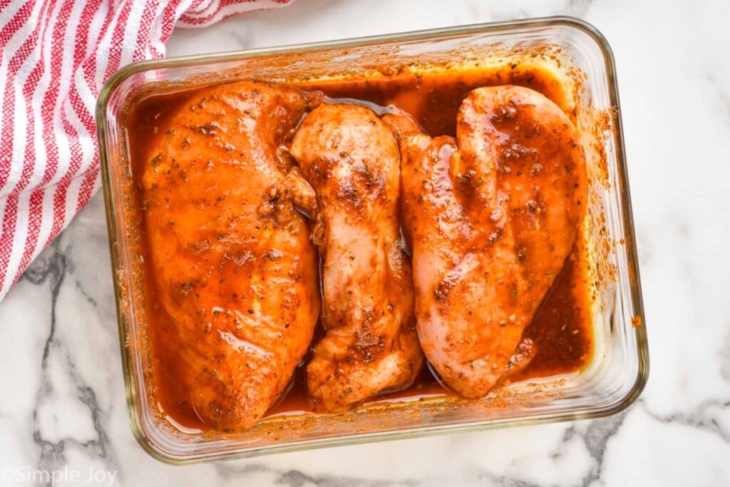 overhead of chicken marinating in pan to make chicken fajitas