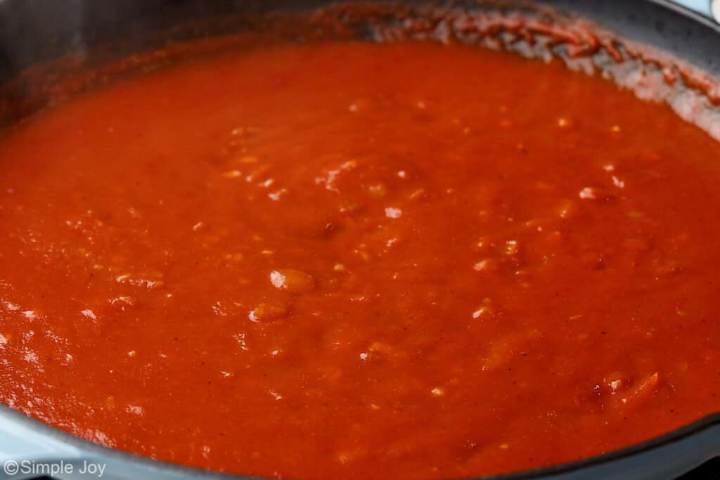 tomato sauce added to a skillet to make enchilada sauce