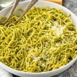 bowl of pesto pasta topped with parmesan cheese - 11