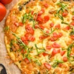 Overhead photo of Pesto Pizza. Tomatoes and bottle opener next to pizza. - 15
