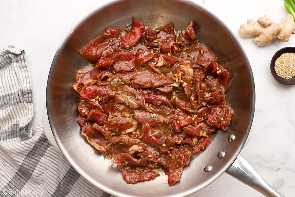 overhead of beef for beef stir fry cooking in a skillet
