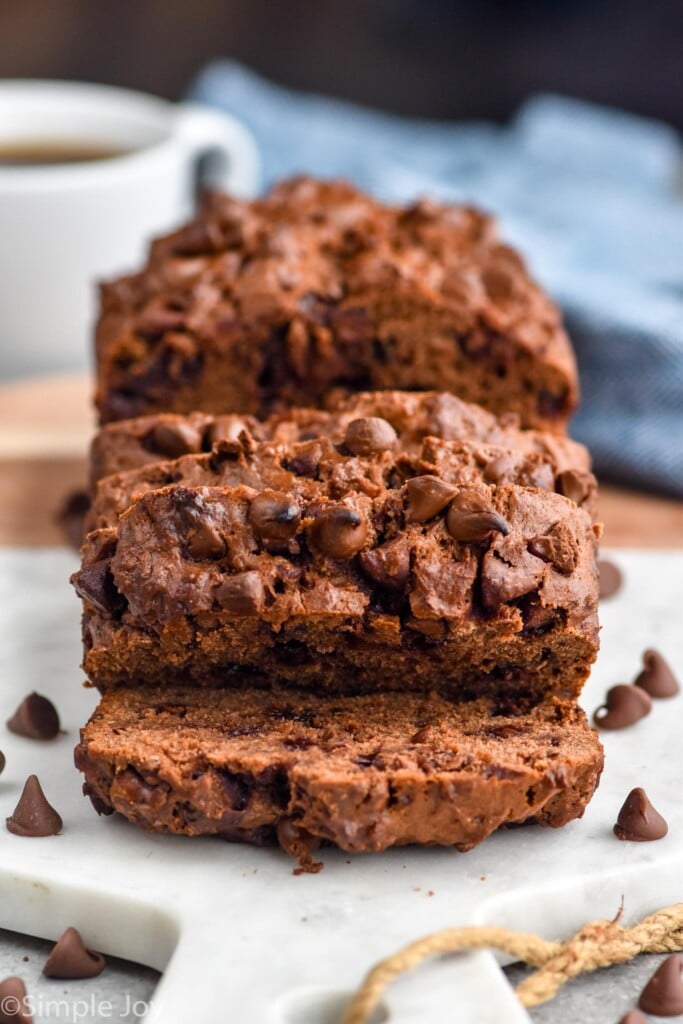 Loaf of Chocolate Banana Bread sliced on a serving board