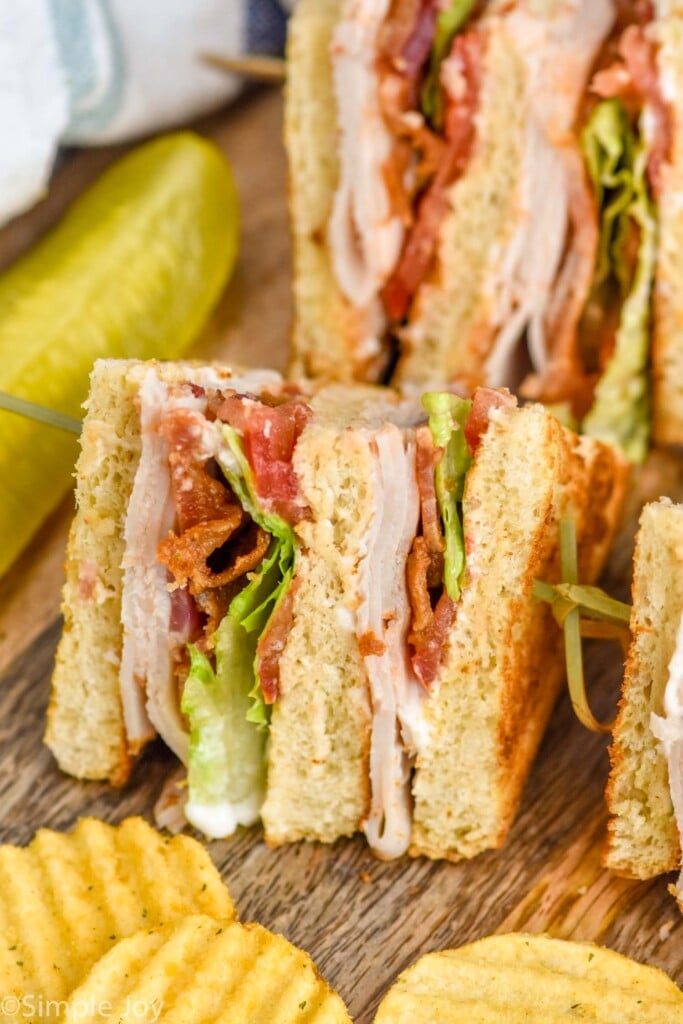 Club sandwich with chips and a pickle spear