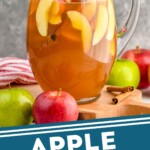 Pinterest graphic for Apple Cider Sangria recipe. Image is side view of a pitcher of Apple Cider Sangria with apples and cinnamon sticks beside pitcher. Text says, "Apple Cider Sangria simplejoy.com"