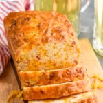 Pinterest graphic for Bacon Cheese Beer Bread recipe. Text says, "mouth watering Bacon Cheese Beer Bread simplejoy.com." Image shows partially sliced loaf of Bacon Cheese Beer Bread.