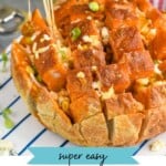 pinterest graphic for buffalo pull apart bread. Image shows man's hand pulling piece of Buffalo Pull Apart Bread from loaf. Text says "super easy buffalo pull apart bread simplejoy.com"
