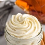 Pinterest image for maple frosting. Text says "the best maple frosting simplejoy.com" Image shows a jar of maple frosting.