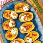 Pinterest graphic for Potato Skins recipe. Text says, "the best Potato Skins simplejoy.com." Image is overhead photo of a platter of Potato Skins.