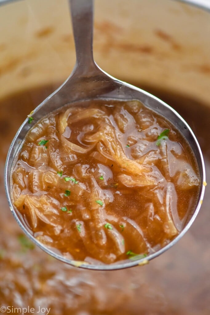 Close up photo of a ladle of French Onion Soup