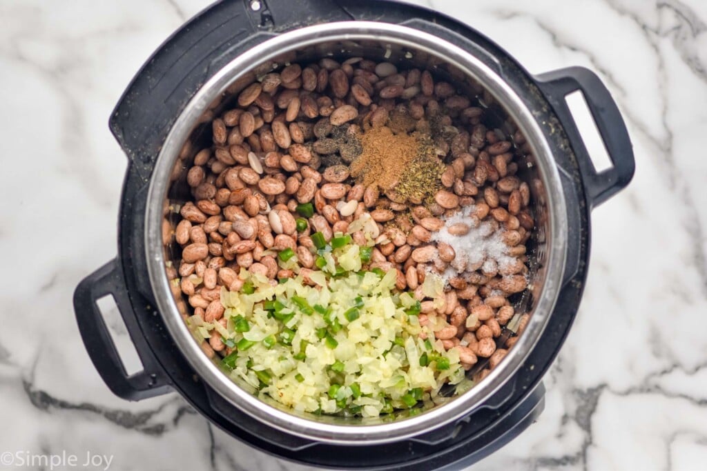overhead of instant pot with ingredients to make instant pot pinto beans recipe