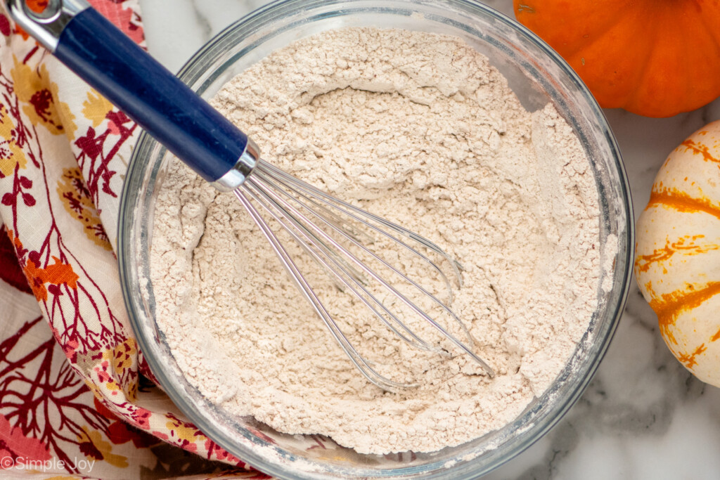 overhead of a bowl of dry ingredients mixed together for pumpkin and chocolate chip muffins