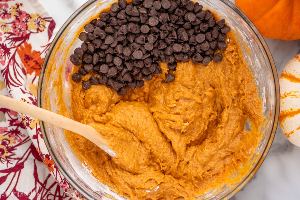 batter for pumpkin muffins with chocolate chips being mixed in