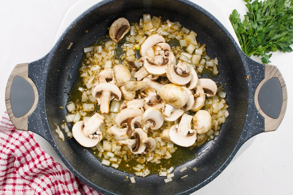 mushrooms and onions in a skillet to start a mushroom gravy for salisbury steak