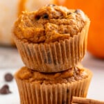 two pumpkin chocolate chip muffins stacked on top of each other - 11